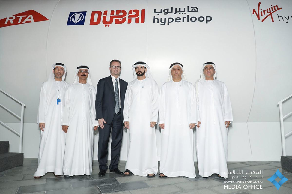 HH Sheikh Hamdan Bin Mohammed Bin Rashid Al Maktoum, HE Mattar Al Tayer, Rob Lloyd, and Sultan Ahmed Bin Sulayem, Board Member of Virgin Hyperloop One outside the Dubai hyperloop pod.
