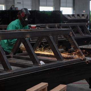 Grinding down the saddle, which holds the tubes until they are ready to go into place, at our Metalworks shop in Las Vegas.