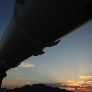 The shadow of an overhead tube during the desert sunrise.